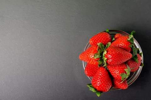 Strawberries on the black background Stock Photos
