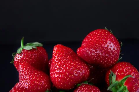 Strawberries on a black background Stock Photos