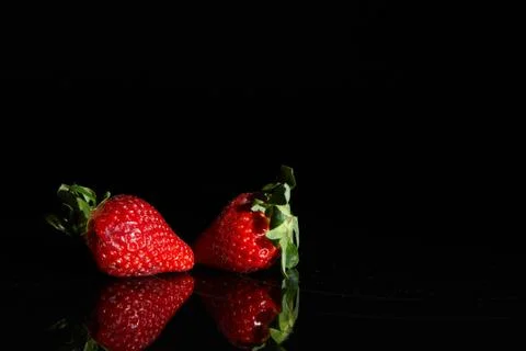 Strawberries on a black background with reflection Stock Photos