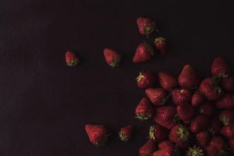 Strawberries on black rustic background Stock Photos