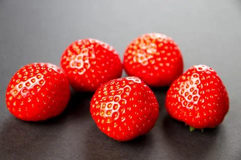 Strawberries on black table Stock Photos