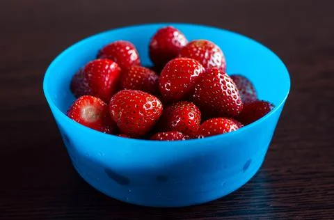 Strawberries in a blue bowl, isolated, healthy snack Stock Photos