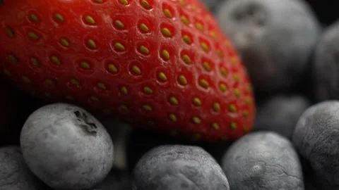 Strawberries with blueberries close up in motion. Soft focus. Stock Footage 102357552