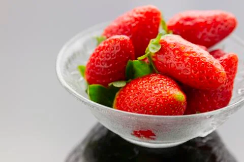 Strawberries in bowl Stock Photos