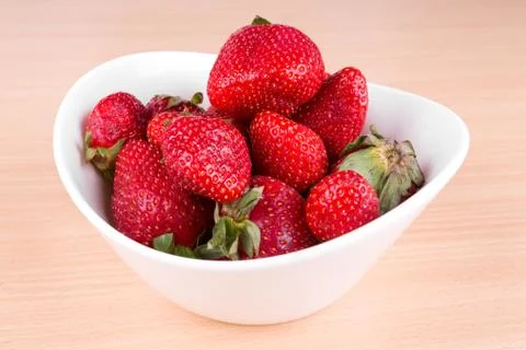 Strawberries in a bowl on the table Stock Photos