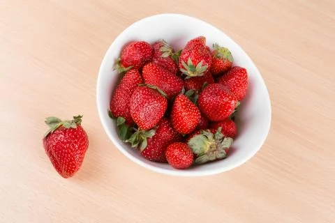 Strawberries in a bowl on the table Stock Photos