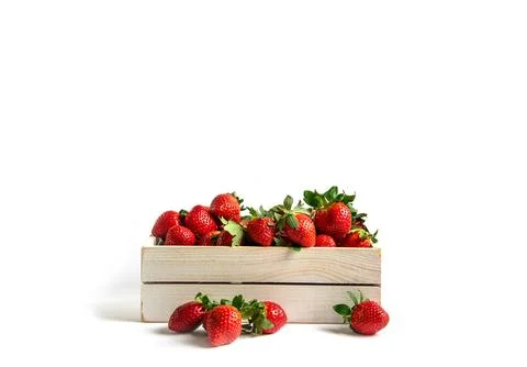 Strawberries in box on a white background with space for text. Stock Photos