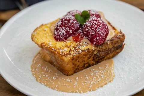 Strawberries on bread pudding with custard Stock Photos