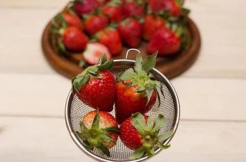 Strawberries in a colander close-up Stock Photos