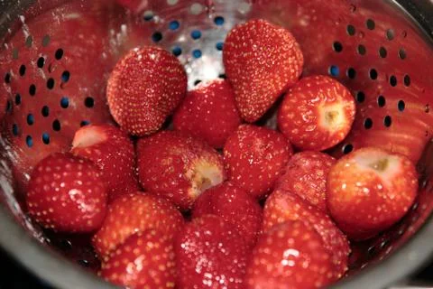 Strawberries in colander Stock Photos