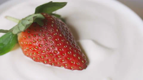 Strawberries in cream Stock Footage 103982943
