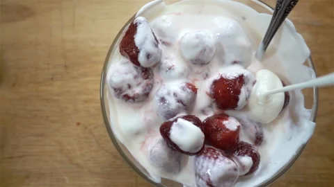 Strawberries with cream in slow motion Stock Footage 145450141