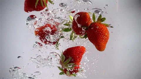 Strawberries fall into the water - Slow Motion Stock Footage 74911346