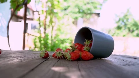 Strawberries fall on the wooden table. Stock Footage 169147233