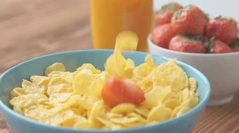 Strawberries falling into cereal in slow motion Stock Footage 68952170