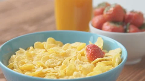 Strawberries falling into cereal in slow motion Stock Footage 68952338
