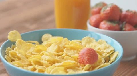 Strawberries falling into cereal in slow motion Stock Footage 68952472