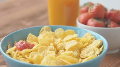 Strawberries falling into cereal in slow motion Stock Footage 68952564
