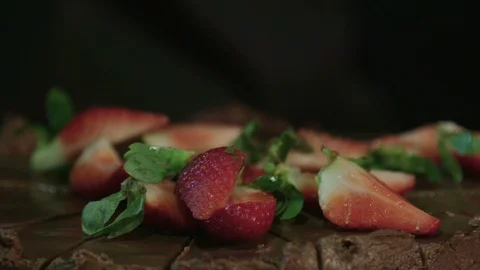 Strawberries falling on a chocolate cake in slow motion Stock Footage 129016519