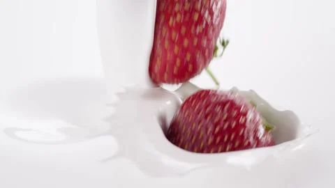Strawberries falling into the flow of milk Stock Footage 171888590
