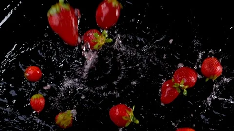 Strawberries falling on water on black background Stock-Footage 91104111