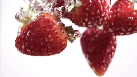 Strawberries falling in water slow motion Stock Footage 103401894