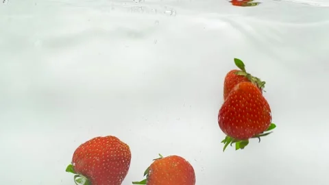  Strawberries falling into water with slowdown Stock Footage 201285561