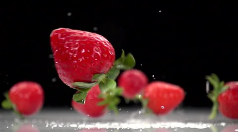 Strawberries falling on a white surface in slow motion. Stock Footage 61643133