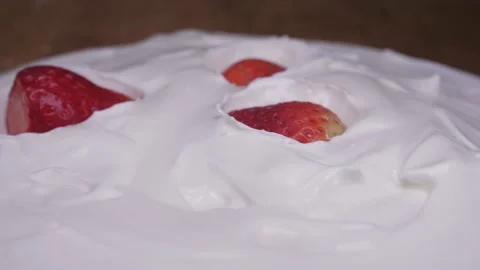Strawberries falling in yogurt 4k Stock Footage 150600941