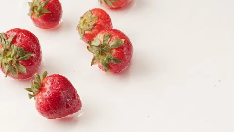 Strawberries Floating in Milk Stock Footage 309822836