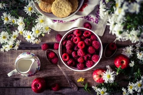 Strawberries with flowers keeps on table Stock Photos