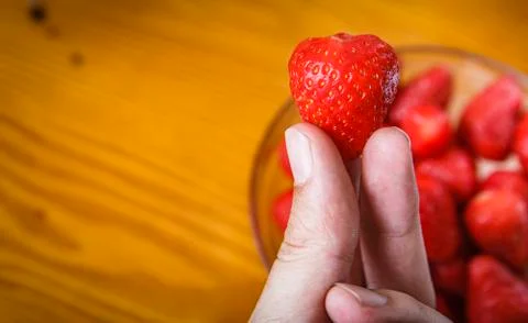 Strawberries in hand Stock Photos