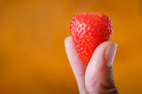 Strawberries in hand Stock Photos