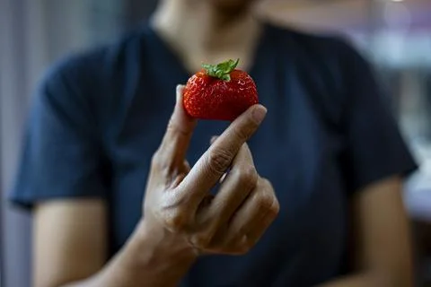 Strawberries In Hand Stock Photos