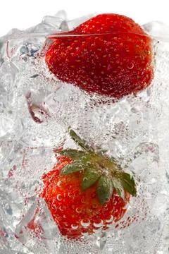 Strawberries in ice cubes Stock Photos
