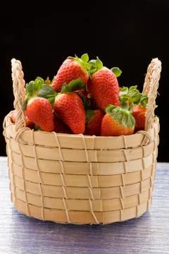 Strawberries inside a basket Stock Photos