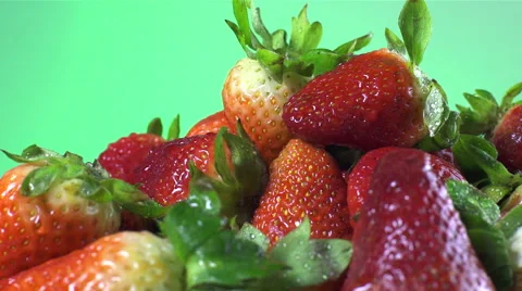 Strawberries isolated rotating on green background Stock Footage 62394377