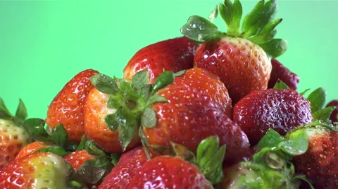 Strawberries isolated rotating on green background Stock Footage 62394890