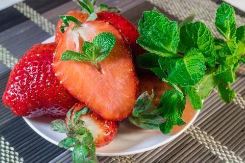 Strawberries with mint on a plate Stock Photos