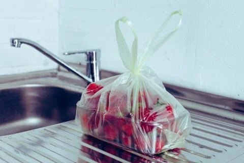 Strawberries in a package on the table Stock Photos