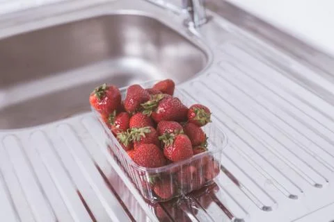 Strawberries in the package on the table Stock Photos