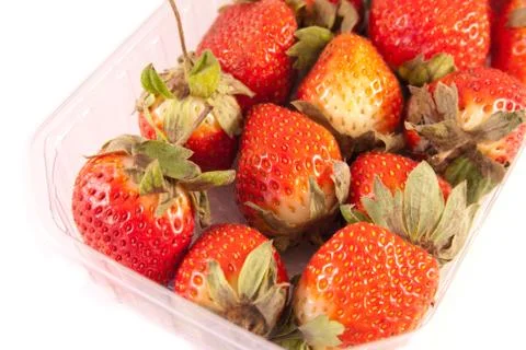 Strawberries in a plastic container Stock Photos
