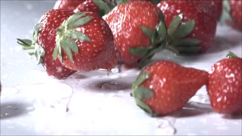 Strawberries Rolling Down on White Background. Slow Motion Stock Footage 246478123