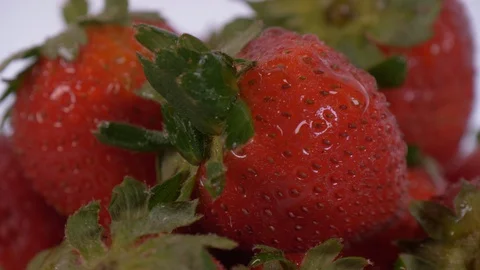 Strawberries Rotating over white Background with Water on them. Strawberries Stock-Footage 127936554