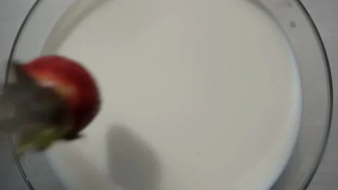 Strawberries slow motion fall of milk. Stock Footage 132348377