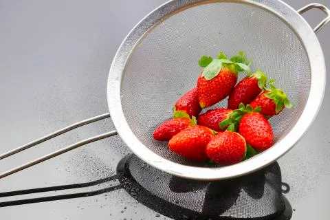 Strawberries in strainer Stock Photos