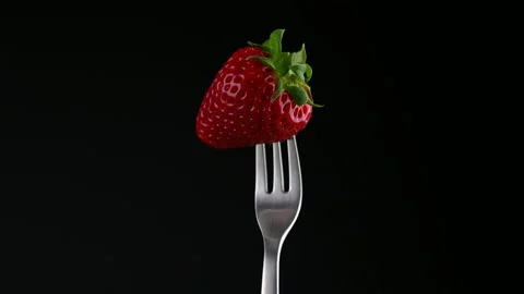 Strawberries stuck on a fork Stock Footage 153004597