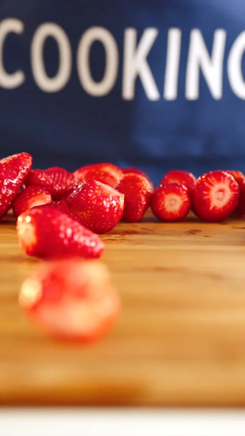 Strawberries tumble joyfully across the kitchen table Stock Footage 341762703