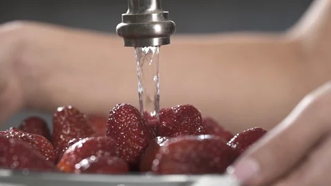 Strawberries under the tap, slow motion stock vide Stock Footage 107888694