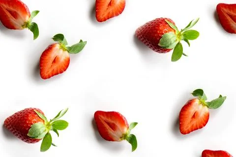 Strawberries on a white background. Pattern of whole berries and halves in ra Stock Photos